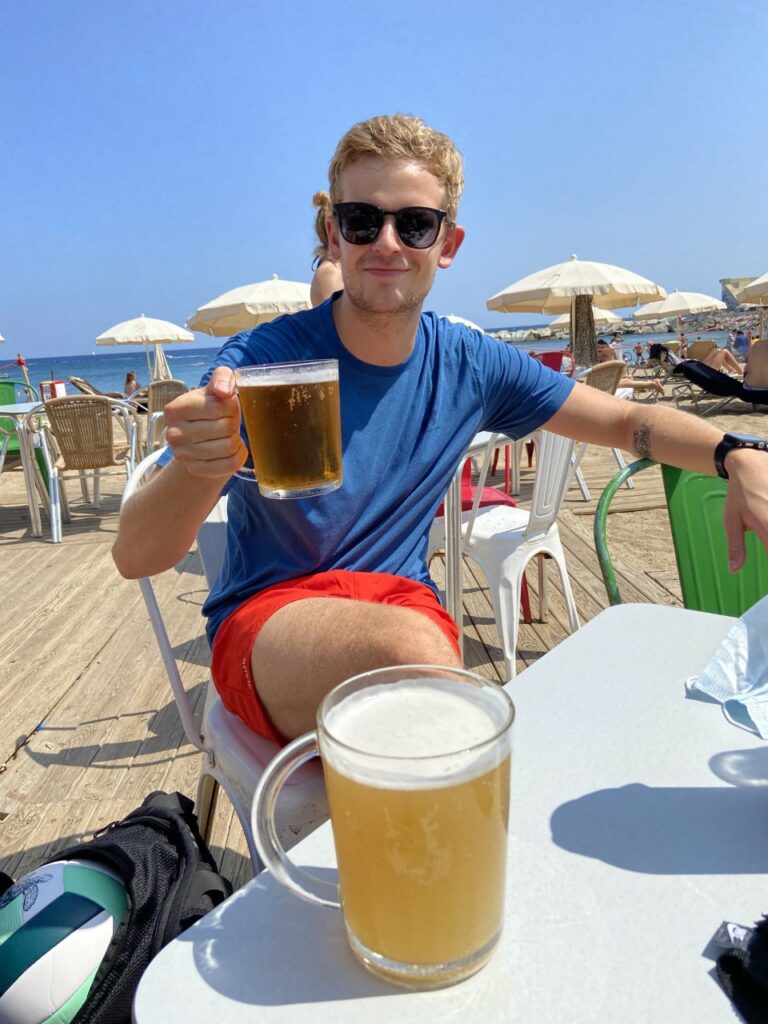  Ari Fridfinnsson a B2C Marketing Management student at TBS Education in Barcelona drinking a beer in Barcelona Beach